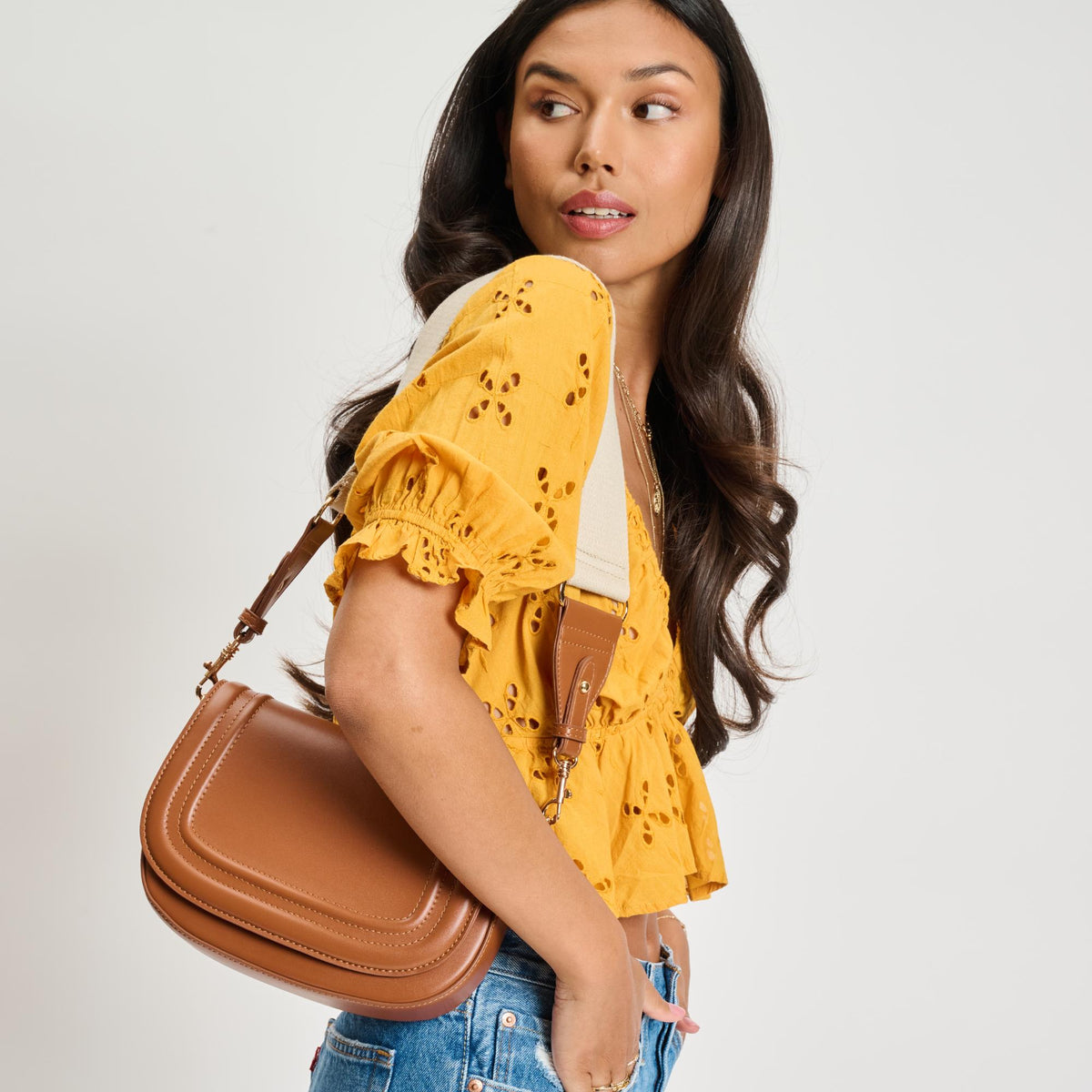 Woman wearing Tan Moda Luxe Poshette Crossbody 842017134749 View 1 | Tan