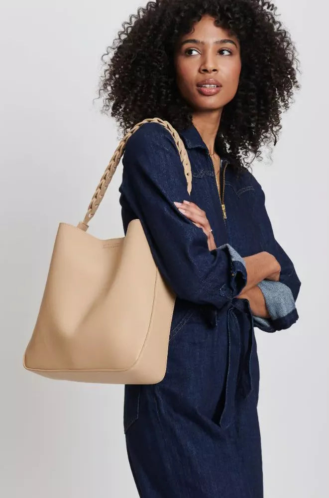 a woman holding a luxury handbag