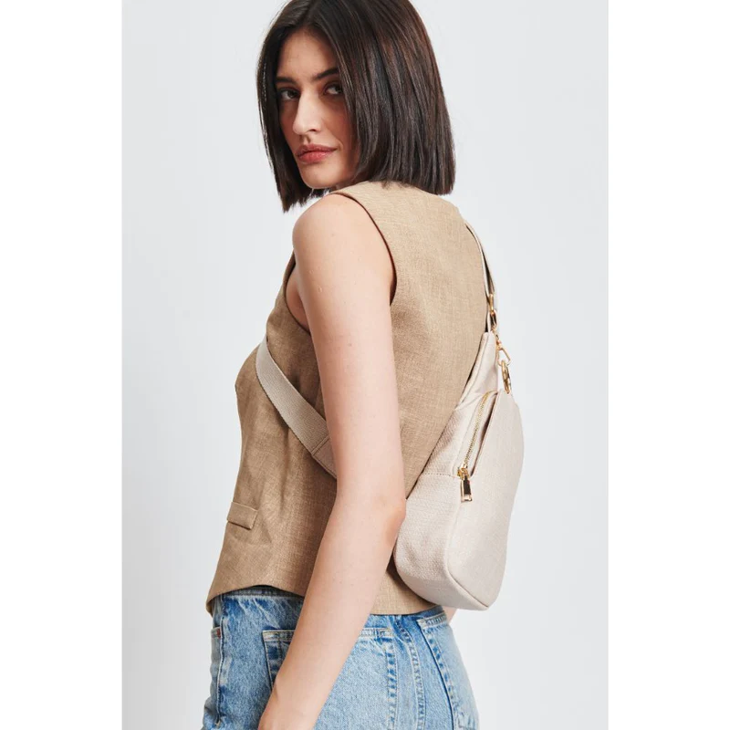 A woman wearing the Regina Sling Backpack