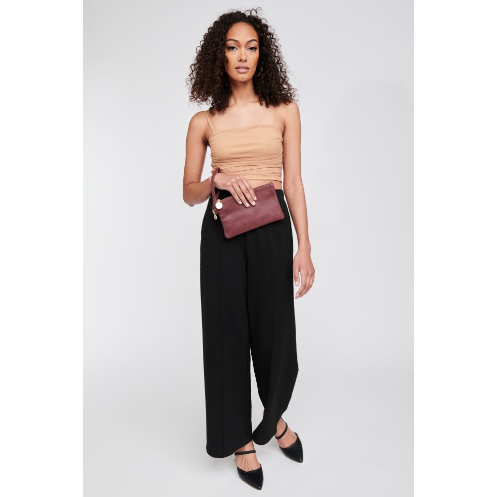 Woman wearing Burgundy Moda Luxe Olivia Wristlet 842017117926 View 2 | Burgundy
