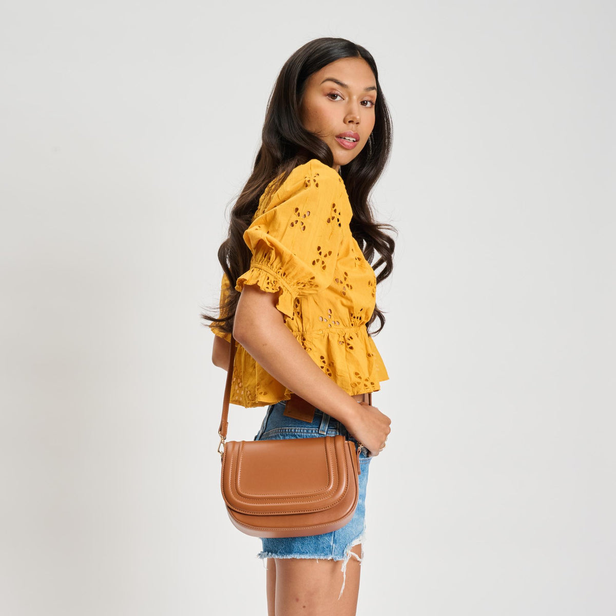 Woman wearing Tan Sol and Selene Poshette Crossbody 842017134749 View 3 | Tan