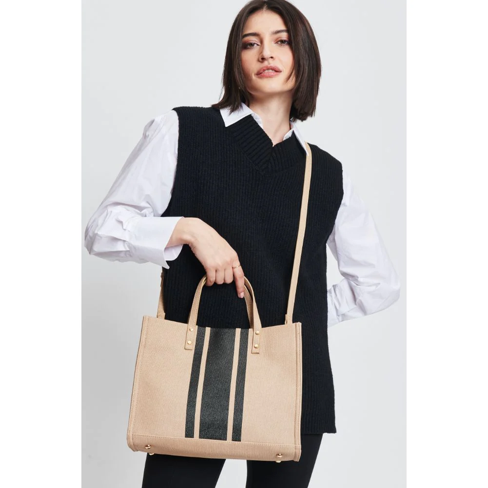 Woman in black pantsuit and white shirt holds wholesale-leather-bag